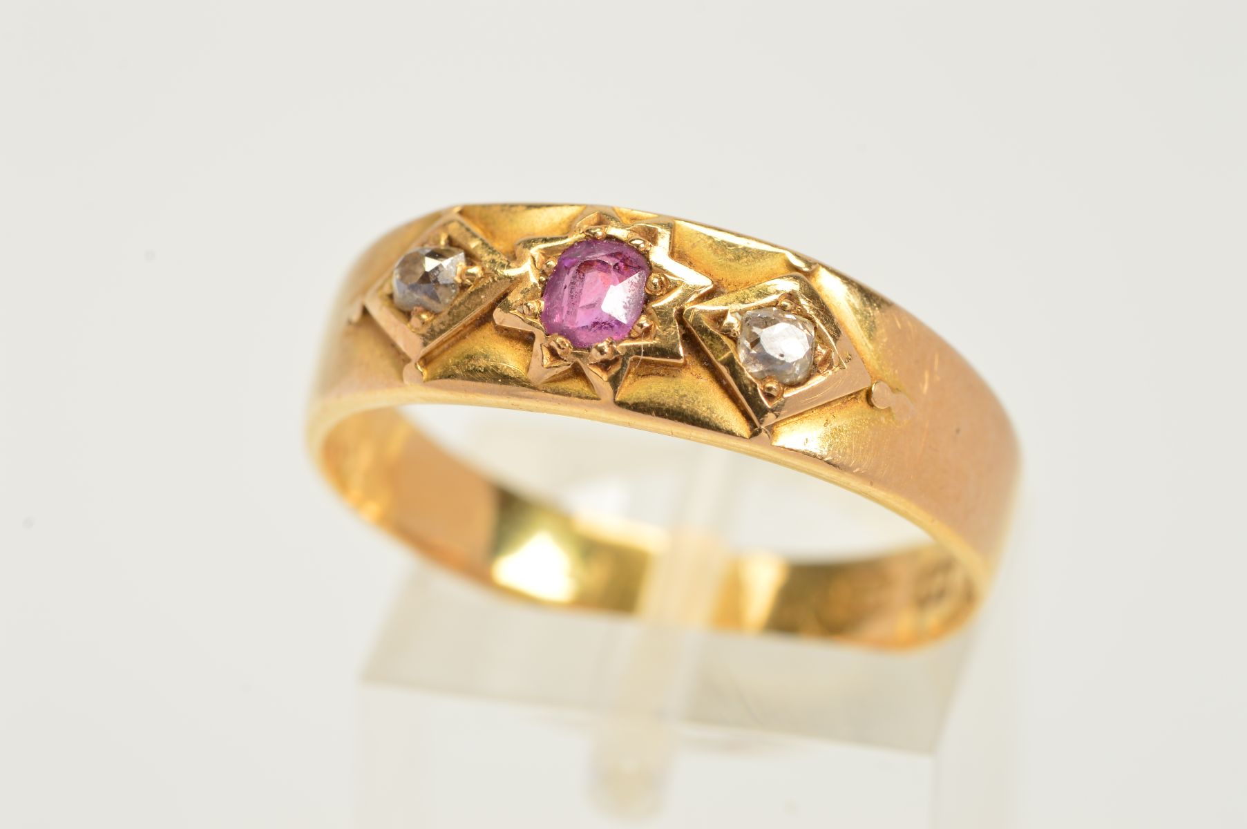 A MID VICTORIAN 18CT GOLD RUBY AND DIAMOND RUBY RING, designed as a central circular ruby within a