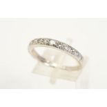 AN 18CT WHITE GOLD RING, designed as a half eternity ring set with twelve slightly graduated