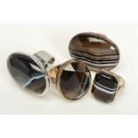 FOUR BANDED AGATE RINGS, two designed as oval banded agate cabochons each within a collet setting,