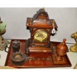 A MANTEL CLOCK, Arabic numerals, dial distressed, with key and pendulum, a carved 'owls' ashtray,