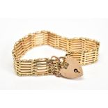 A GATE BRACELET, designed with a heart padlock clasp and safety chain, stamped 15ct, length 180mm,