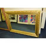 A MODERN FOLIATE GILT FRAMED WALL MIRROR, 115cm x 83cm