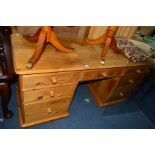 A PINE DESK with an assortment of five drawers, width 163cm x depth 61cm x height 82cm