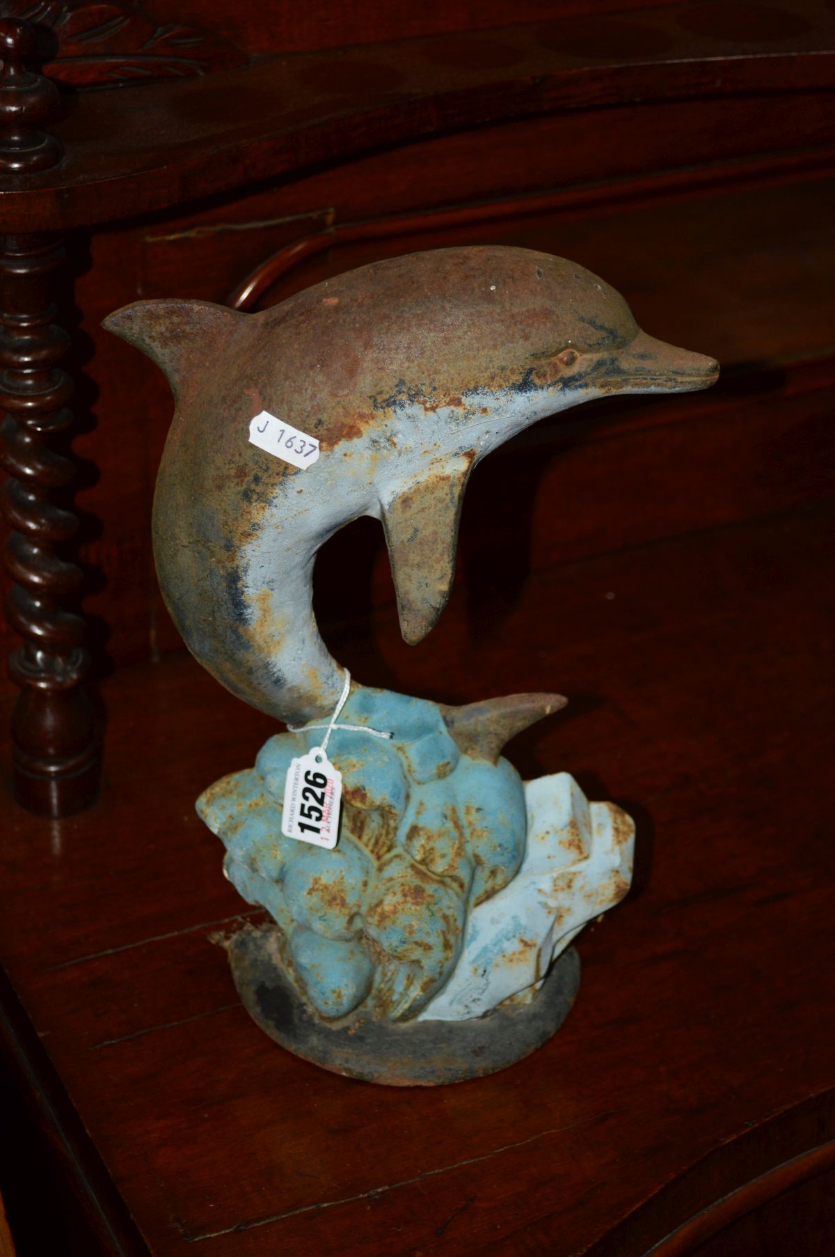 A CAST IRON DOOR STOP of a Dolphin