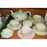 BELLEEK TEAWARES, of shell form, comprising teapot with handle and knop of spout modelled as