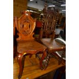 A LATE VICTORIAN OAK HALL CHAIR with a scrolled and shield back together with an oak barley twist