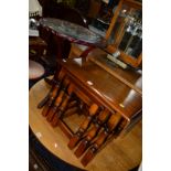 A REPRODUCTION OAK NEST OF THREE TABLES together with a mahogany circular glass topped occasional
