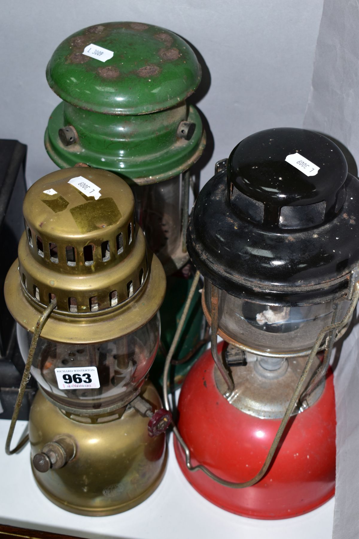 AN OPTIMUS 930 BRASS PARAFFIN STORM LAMP, with two unmarked paraffin storm lamps (3)