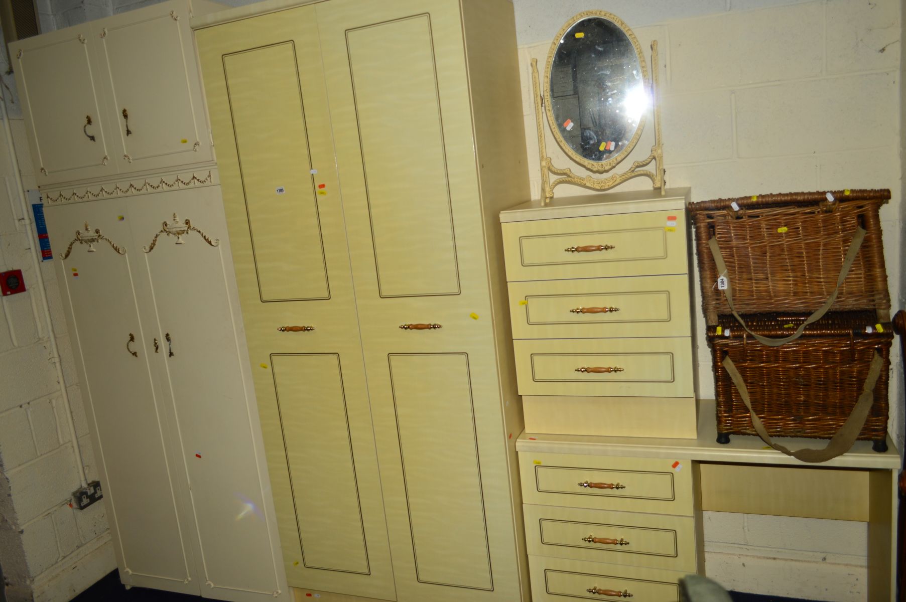 A CREAM THREE PIECE BEDROOM FITMENT, comprising of a double door wardrobe, dressing table and a