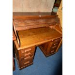 AN EARLY TO MID 20TH CENTURY OAK ROLL TOP DESK with eight various drawers, width 122cm x depth