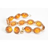 A MODIFIED AMBER BRACELET AND MATCHING EARRINGS, the bracelet designed as modified amber cabochons