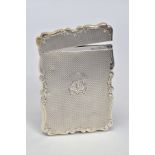 A LATE VICTORIAN SILVER CARD CASE OF WAVY RECTANGULAR OUTLINE, hinged top, engine turned