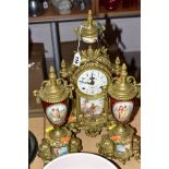 A GERMAN BRASS CLOCK GARNITURE, in the Louis XIV style, with painted panels, enamel dial with Arabic
