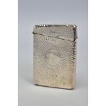 AN EDWARDIAN SILVER RECTANGULAR CARD CASE, hand hammered finish, vacant circular cartouche, maker'