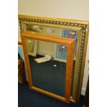 A MODERN BEVELLED EDGE WALL MIRROR, 105cm x 77cm and a pine wall mirror (2)