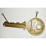 A YALE & TOWNE PENDANT ADVERTISING SIGN, in the form of a Yale Key, of cast metal construction,
