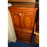 A YEW WOOD TWO DOOR CABINET