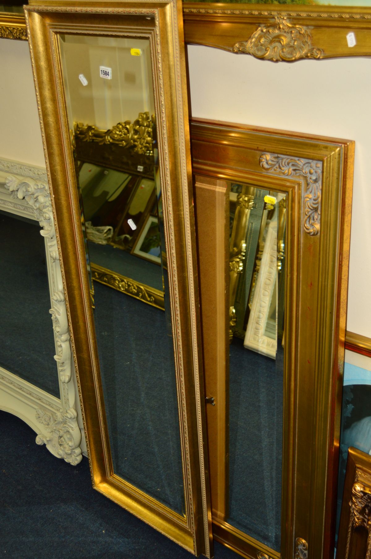 A MODERN RECTANGULAR GILT FRAMED BEVELLED EDGE WALL MIRROR, 45cm x 136cm together with two other