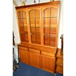 A MID TO LATE 20TH CENTURY TEAK SIDEBOARD with three cupboard doors and flanked by three drawers,