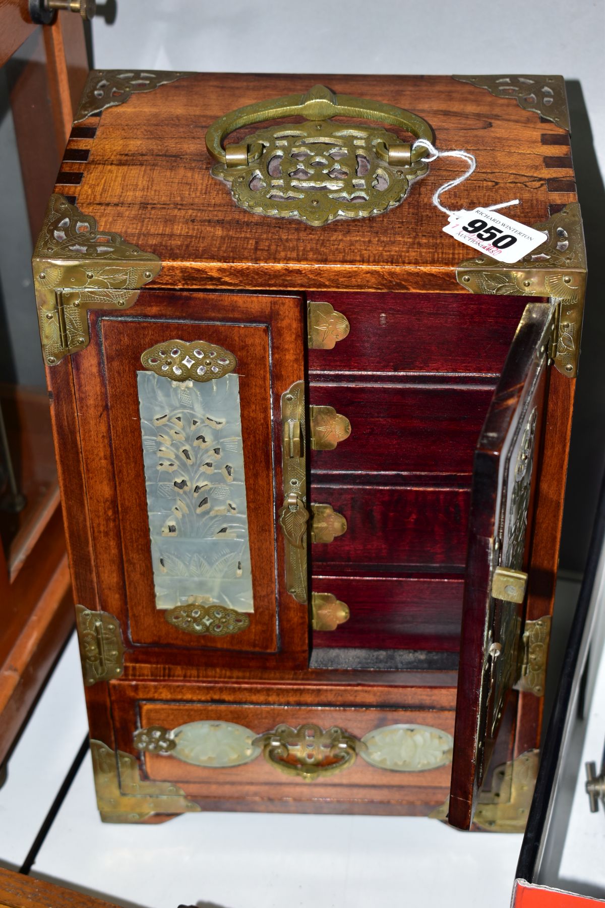 A CHINESE JEWELLERY BOX, circa 1930's, having brass handles and corners, the doors and sides inset