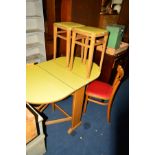 A YELLOW FORMICA TOPPED DROP LEAF DINING TABLE, two dining chairs and a pair of stools (5)