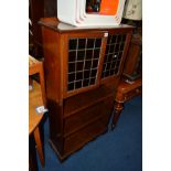 AN EDWARDIAN MAHOGANY LEAD GLAZED TWO DOOR BOOKCASE above triple open shelving, width 76cm x depth