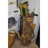 A LIGHT BROWN VINTAGE GOLF BAG CONTAINING VARIOUS PING GOLF CLUBS together with a golf bag