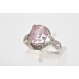 A 9CT WHITE GOLD KUNZITE AND DIAMOND DRESS RING, designed as a central oval kunzite within a waved