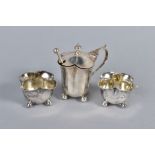 A LATE VICTORIAN SILVER THREE PIECE CRUET SET OF QUATREFOIL OUTLINE, with three matching spoons,