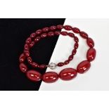 A RED PLASTIC BEAD NECKLACE, designed as thirty six graduated barrel shape beads measuring