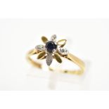 AN 18CT GOLD SAPPHIRE AND DIAMOND FLOWER RING, designed as a central claw set circular sapphire,