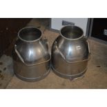 A PAIR OF STAINLESS STEEL MILK CHURNS with handles