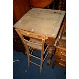 A TALL EARLY 20TH CENTURY PITCH PINE SLOPED DESK, width 61cm x depth 56cm x height 106cm and an