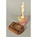 AN EARLY 20TH CENTURY CARVED IVORY FIGURE, of a nude lady mounted on a circular onyx base, height