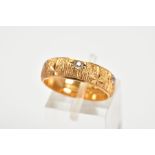 A 22CT GOLD RING, designed as a textured band set with four old cut diamonds and one brilliant cut