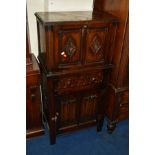 A REPRODUCTION OAK LINEN FOLD FALL FRONT DRINKS CABINET with a single drawer and cupboard, width