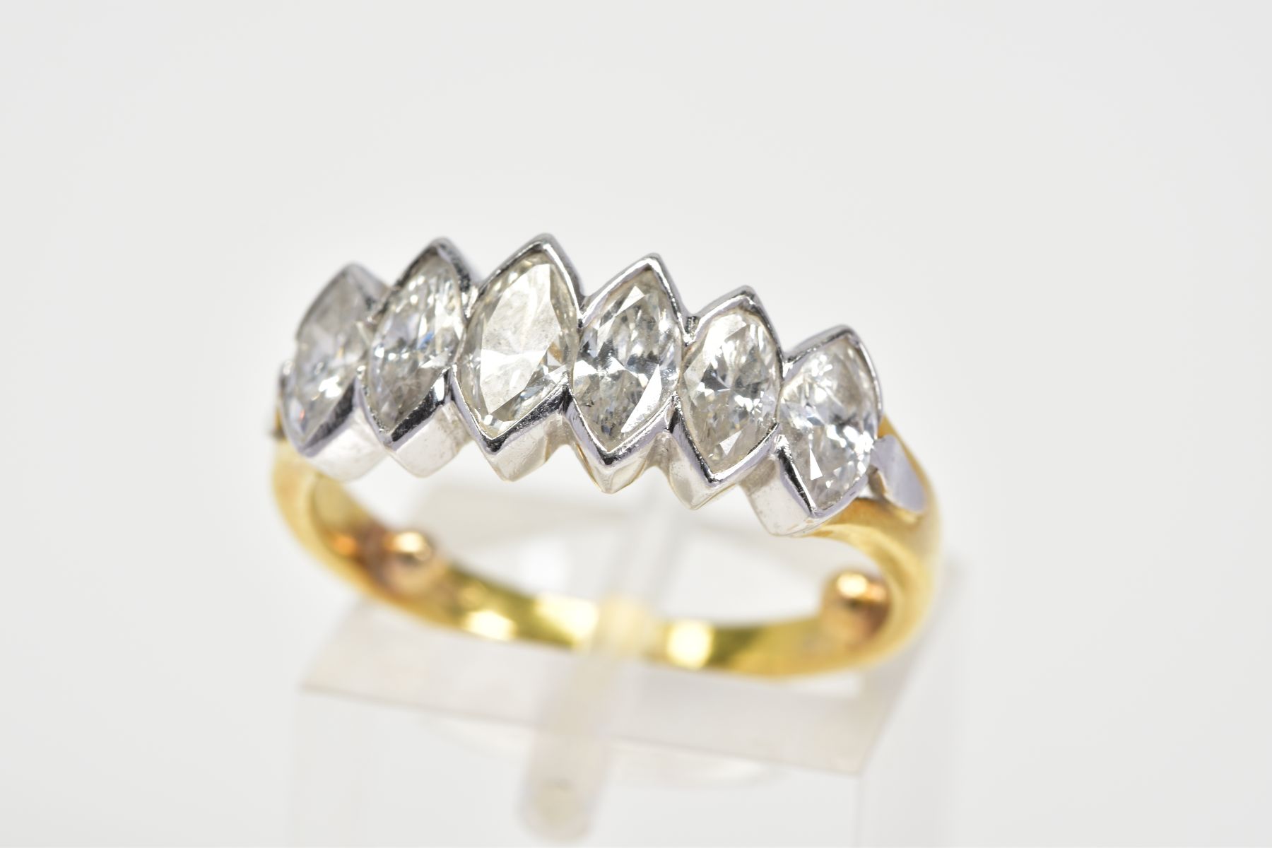 A DIAMOND RING, designed with six marquise cut diamonds in collet mounts to the plain polsihed band,