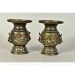 A PAIR OF LATE 19TH CENTURY JAPANESE BRONZE TWIN HANDLED VASES, embossed bird and turtle decoration,