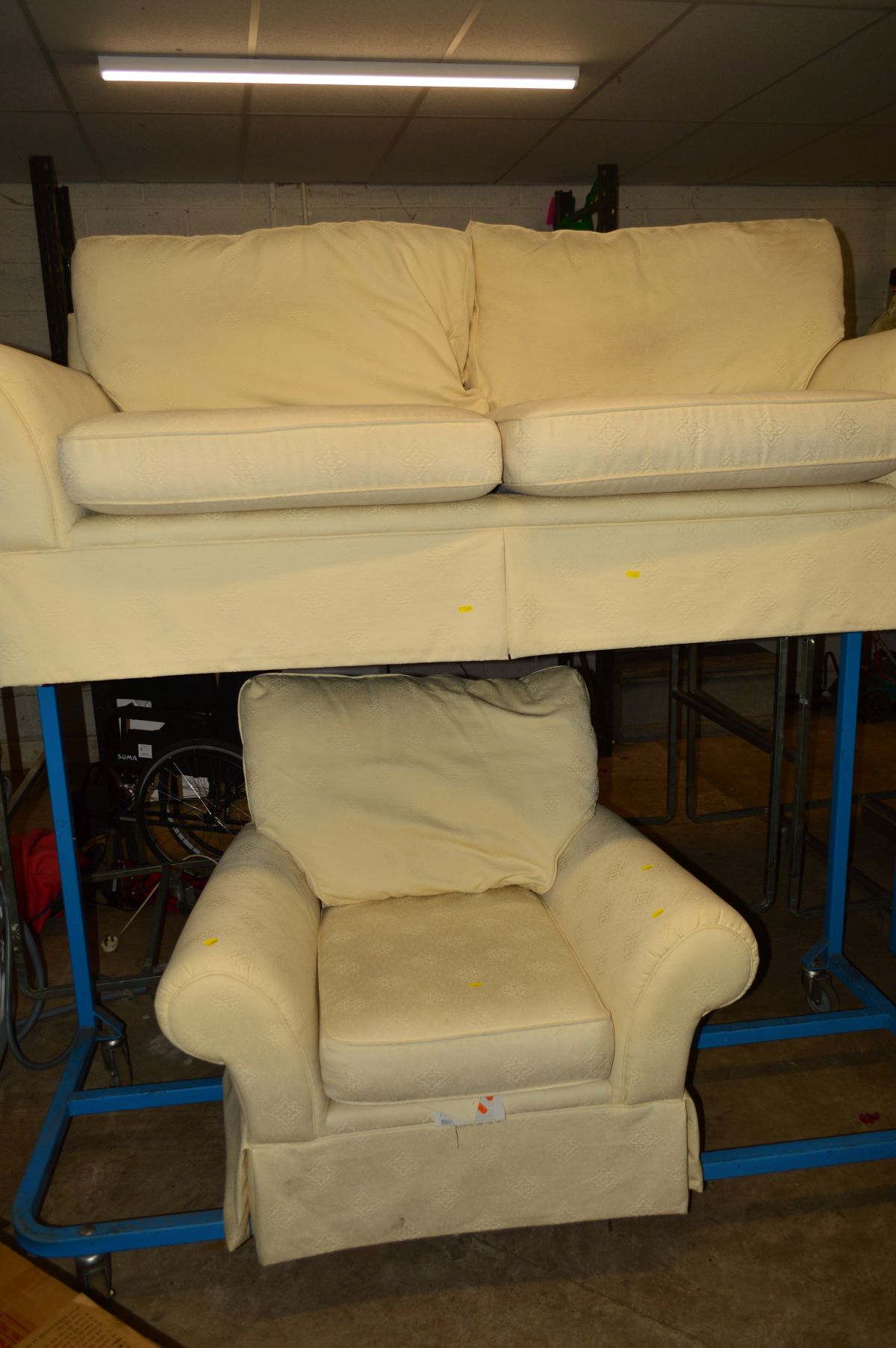 A CREAM UPHOLSTERED TWO SEATER SETTEE with matching armchair (2)