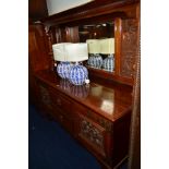 AN EDWARDIAN WALNUT MIRROR BACK SIDEBOARD with foliage and mythical creature panels, the top with