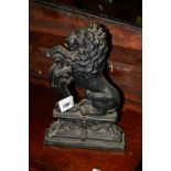 A CAST IRON LION DOOR STOP