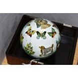 AN EARLY 20TH CENTURY DECALOMANIA GLASS BALL, decorated with animals and butterflies, approximate