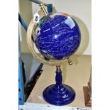 A GLOBE, ON STAND, INSET WITH SEMI PRECIOUS STONES, having brass stand set in to blue resin weighted