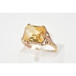 A 9CT GOLD CITRINE RING, designed as a rectangular cut citrine within a four claw setting to the