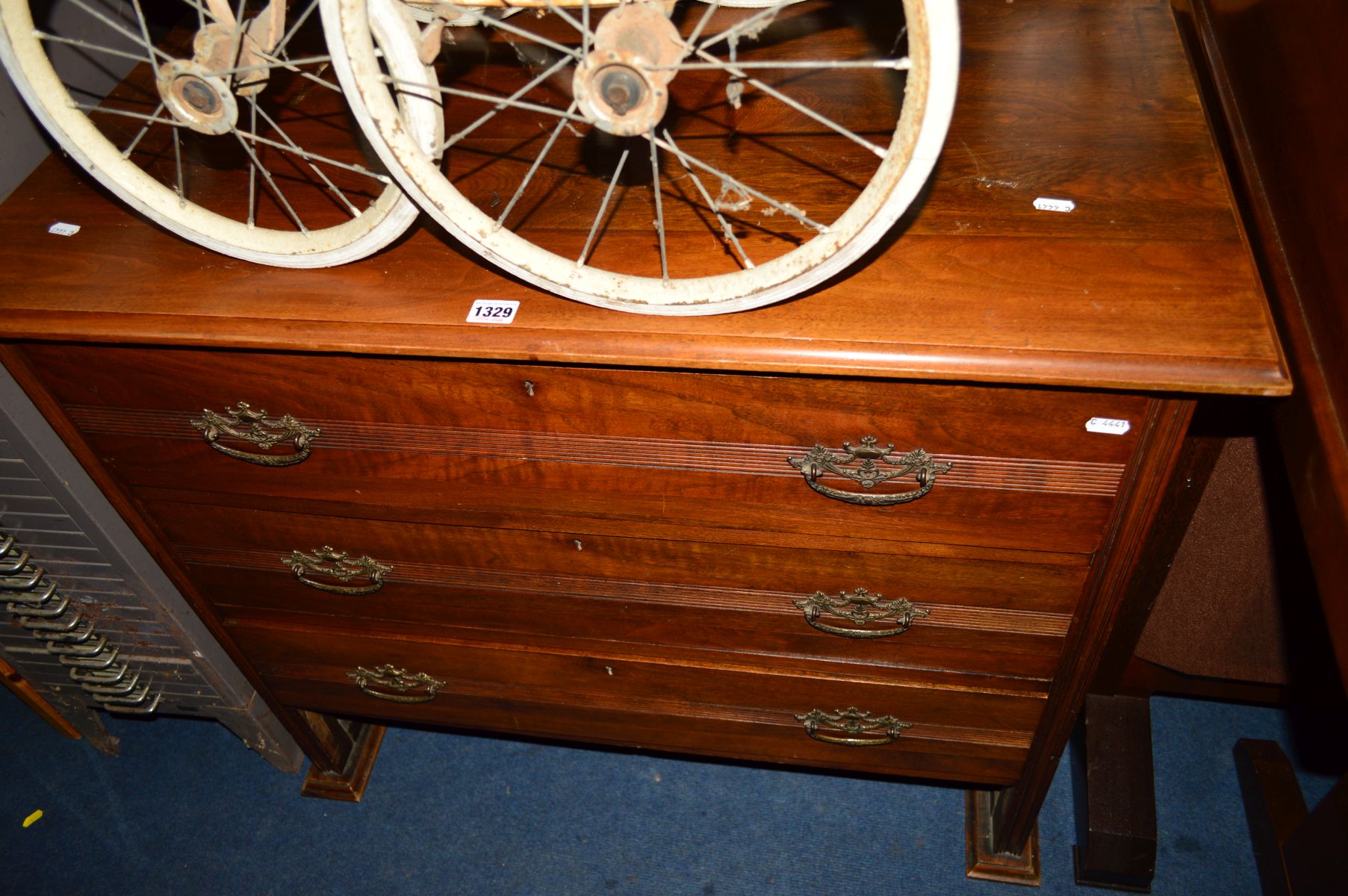 AN EDWARDIAN WALNUT CHEST OF THREE LONG DRAWERS