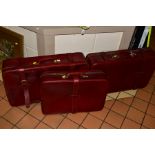 A PAIR OF HARRODS OF LONDON BURGUNDY LEATHER SUITCASES WITH LOCKING KEY, approximate size width 72cm