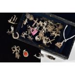 A SELECTION OF MAINLY CHARMS, to include a hinged church charm with Stanhope 'Window' showing the