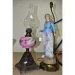 A SINGLE BURNER OIL LAMP, having pink glass reservoir decorated with foliate decoration and having