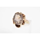 A SMOKEY QUARTZ RING, designed as an oval smokey quartz within a scalloped claw setting, ring size