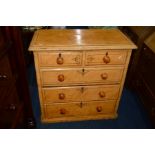 A VICTORIAN PAINTED AND SCUMBLED PINE CHEST OF TWO SHORT AND THREE LONG DRAWERS with turned handles,